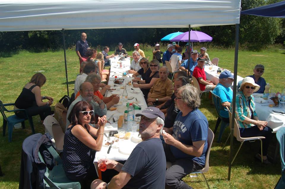 Groupe de bénévoles de l’Aérodrome Bretagne Atlantique partageant un repas en plein air.